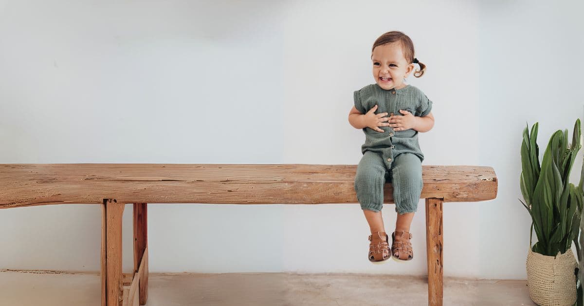 Happy toddler wearing EPIC clothing in natural setting